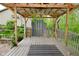 Backyard deck with a metal roof and wooden railing providing a cozy outdoor seating area for relaxation and entertainment at 6567 Kings Ct, Avon, IN 46123