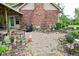 Charming backyard featuring a brick exterior, beautiful stone patio with well-manicured landscaping and unique outdoor decor at 6567 Kings Ct, Avon, IN 46123