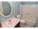 Bathroom with vanity sink, toilet, and shower with blue textured walls at 6567 Kings Ct, Avon, IN 46123