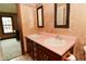 Bathroom featuring double sinks with framed mirrors and wood cabinets at 6567 Kings Ct, Avon, IN 46123