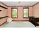 Bedroom featuring two windows, wood trim, and built in shelving at 6567 Kings Ct, Avon, IN 46123