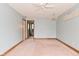 Empty blue bedroom featuring chandelier, ceiling fan, and entrance to additional room at 6567 Kings Ct, Avon, IN 46123