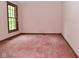 Bedroom with pink walls, carpet flooring, and a bright window at 6567 Kings Ct, Avon, IN 46123