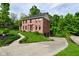 Brick home with green lawn, driveway, and large trees at 6567 Kings Ct, Avon, IN 46123
