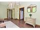 Inviting foyer with hardwood floors, elegant chandeliers, and an antique mirror over a decorative chest at 6567 Kings Ct, Avon, IN 46123