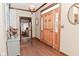 Foyer with natural wood front door and hardwood floors at 6567 Kings Ct, Avon, IN 46123