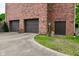Exterior view of a three-car garage with brick facade and convenient driveway access to the home at 6567 Kings Ct, Avon, IN 46123