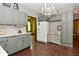 Spacious kitchen with gray cabinets, white appliances, and a chandelier at 6567 Kings Ct, Avon, IN 46123