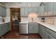 Kitchen with grey cabinets, stainless steel dishwasher, and hardwood floors at 6567 Kings Ct, Avon, IN 46123
