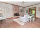 Cozy living room featuring a classic brick fireplace and wood flooring at 6567 Kings Ct, Avon, IN 46123