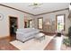 Bright living room with hardwood floors, a cozy couch, and large windows at 6567 Kings Ct, Avon, IN 46123