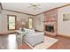 Charming living room with a brick fireplace and hardwood flooring at 6567 Kings Ct, Avon, IN 46123
