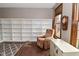 Bright office featuring a wall of shelving and a comfortable recliner chair at 6567 Kings Ct, Avon, IN 46123