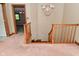 Staircase with wooden railings leading to the lower level at 6567 Kings Ct, Avon, IN 46123