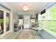 Bright sunroom with many windows, beadboard walls, and a ceiling fan providing a light-filled, comfortable space at 6567 Kings Ct, Avon, IN 46123