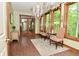 Sunroom with hardwood floors, a chandelier, and large windows with views at 6567 Kings Ct, Avon, IN 46123