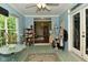 Inviting sunroom with beadboard walls, double doors, and views into the home providing versatile living space at 6567 Kings Ct, Avon, IN 46123