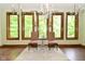 Sunroom with natural light, three large windows, and elegant chandelier at 6567 Kings Ct, Avon, IN 46123