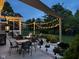 Charming backyard patio offers a cozy fire pit and string lights for intimate outdoor gatherings at 7248 River Birch Ln, Indianapolis, IN 46236