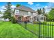 Backyard showing an expansive lawn, patio, privacy fence, and landscaping at 7248 River Birch Ln, Indianapolis, IN 46236