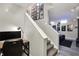 Basement stairs with wall art and a home office area which includes modern decor and a comfortable work space at 7248 River Birch Ln, Indianapolis, IN 46236