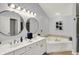 Bright bathroom with double vanity, soaking tub and warm neutral color palette at 7248 River Birch Ln, Indianapolis, IN 46236
