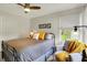 This bedroom includes a view to the outdoors from the window near an accent chair and decorative pillows on the bed at 7248 River Birch Ln, Indianapolis, IN 46236