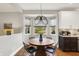 Breakfast nook with a round wooden table, stylish chairs, and big windows for natural light at 7248 River Birch Ln, Indianapolis, IN 46236