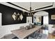 Modern dining room featuring black accent wall, diamond mirrors, and an elegant chandelier at 7248 River Birch Ln, Indianapolis, IN 46236