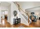 Inviting foyer with hardwood floors, staircase, and stylish decor at 7248 River Birch Ln, Indianapolis, IN 46236