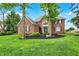 Lovely brick house with a vibrant green lawn and neatly trimmed bushes at 7248 River Birch Ln, Indianapolis, IN 46236