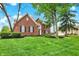 Charming brick home featuring a well-manicured lawn and mature trees at 7248 River Birch Ln, Indianapolis, IN 46236