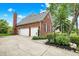 Spacious three-car garage with a brick exterior and ample driveway space at 7248 River Birch Ln, Indianapolis, IN 46236