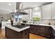 Modern kitchen featuring stainless steel appliances, marble countertops, and kitchen island with cooktop at 7248 River Birch Ln, Indianapolis, IN 46236