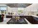 Close up of marble countertop, stainless steel appliances, and two tone cabinetry in a modern kitchen at 7248 River Birch Ln, Indianapolis, IN 46236