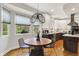 Kitchen and breakfast nook with pendant lighting, and large windows with a view to the yard at 7248 River Birch Ln, Indianapolis, IN 46236