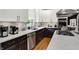 View of sleek modern kitchen, marble counters, stainless appliances, and two tone cabinets at 7248 River Birch Ln, Indianapolis, IN 46236
