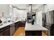 Spacious kitchen with stainless steel appliances, marble countertops and a kitchen island with cooktop at 7248 River Birch Ln, Indianapolis, IN 46236