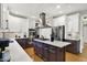 Contemporary kitchen with stainless steel appliances, marble countertops, and kitchen island with cooktop at 7248 River Birch Ln, Indianapolis, IN 46236