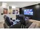 Entertaining living room with theater seating, hardwood floors and a large screen television at 7248 River Birch Ln, Indianapolis, IN 46236