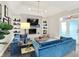 Bright living room with a brick fireplace, built-in shelving, and cozy blue sofas for comfortable seating at 7248 River Birch Ln, Indianapolis, IN 46236