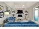 Beautiful living room featuring a brick fireplace, stylish decor, and comfortable seating area with blue couches at 7248 River Birch Ln, Indianapolis, IN 46236
