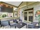 Cozy screened porch with comfortable seating, string lights, and views of the surrounding backyard at 7248 River Birch Ln, Indianapolis, IN 46236