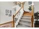 Elegant staircase with carpeted steps and wood banister detailing at 7248 River Birch Ln, Indianapolis, IN 46236