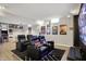 This basement movie room includes a large TV, reclining chairs, gaming machines, and fun decor for entertainment at 7248 River Birch Ln, Indianapolis, IN 46236