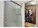 Walk-in closet with sliding glass door and custom shelving and cabinets at 7248 River Birch Ln, Indianapolis, IN 46236