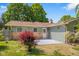Well-maintained backyard featuring a small patio, lush greenery, and colorful landscaping around the house at 8120 E 11Th St, Indianapolis, IN 46219