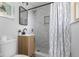Modern bathroom featuring a tiled shower with glass doors, a sleek vanity, and stylish fixtures at 8120 E 11Th St, Indianapolis, IN 46219