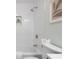 Bathroom featuring a white bathtub and shower with white subway tile at 8120 E 11Th St, Indianapolis, IN 46219