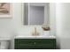 Bathroom featuring a green vanity with a gold faucet and gold mirror at 8120 E 11Th St, Indianapolis, IN 46219